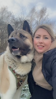 Our staff member Jane Dyson with her lovely doggy smiling outside in the winter.