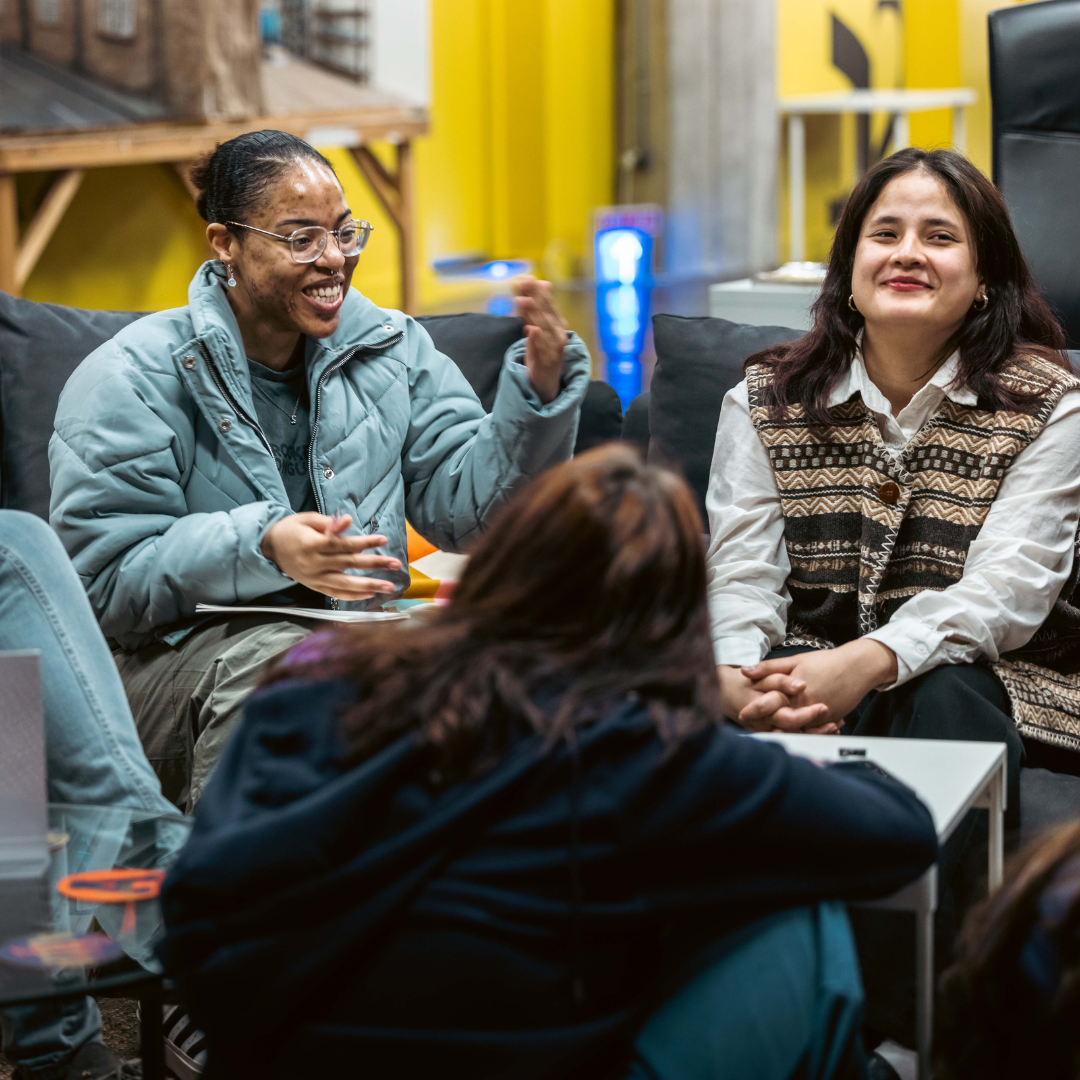 two young filmmakers engage in a group discussion